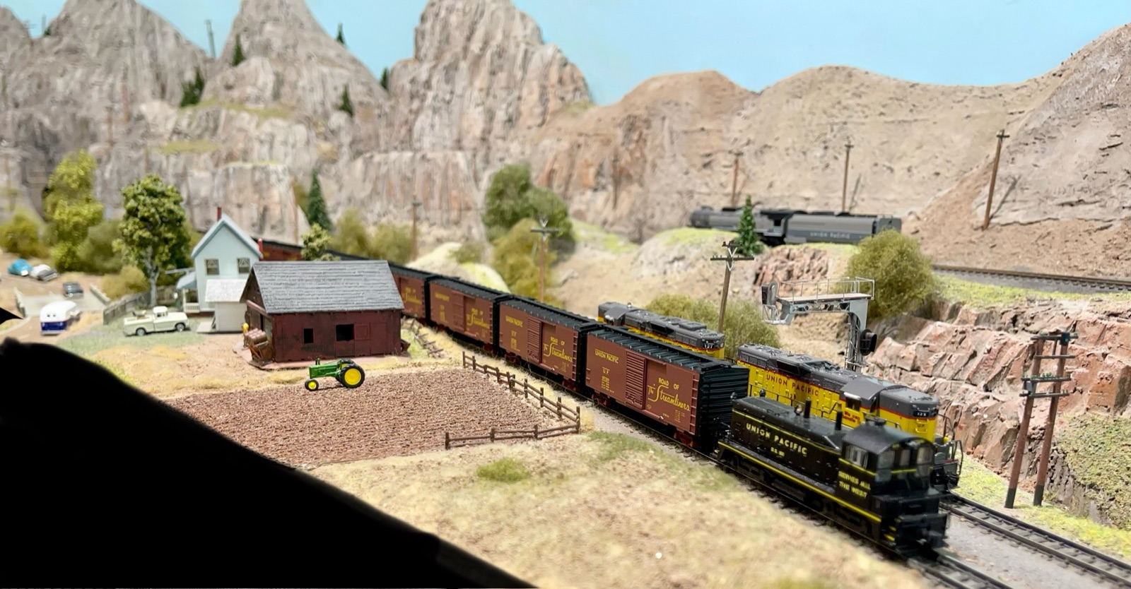 Freight train winding through a red-rock desert canyon