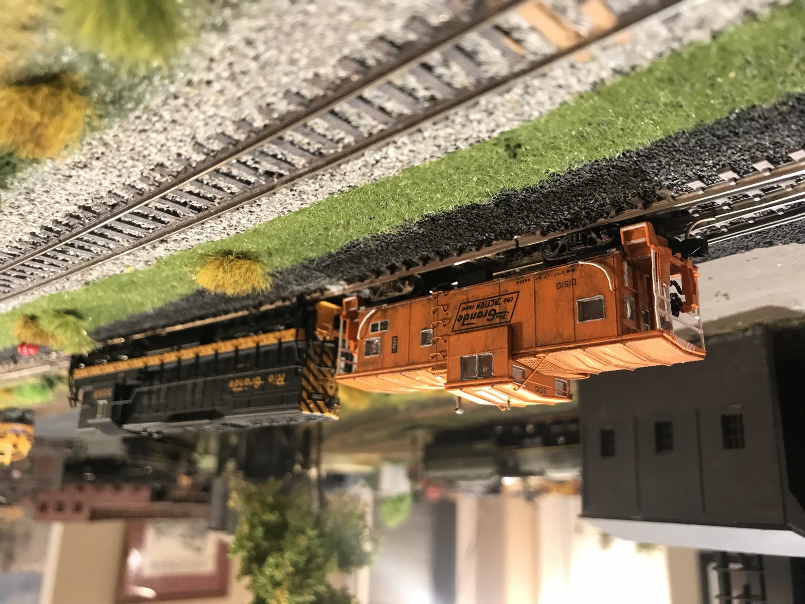 Union Pacific caboose and freight passing a trackside town
