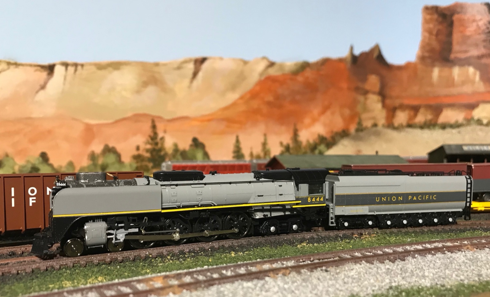 Streamliner passenger train beneath red sandstone buttes