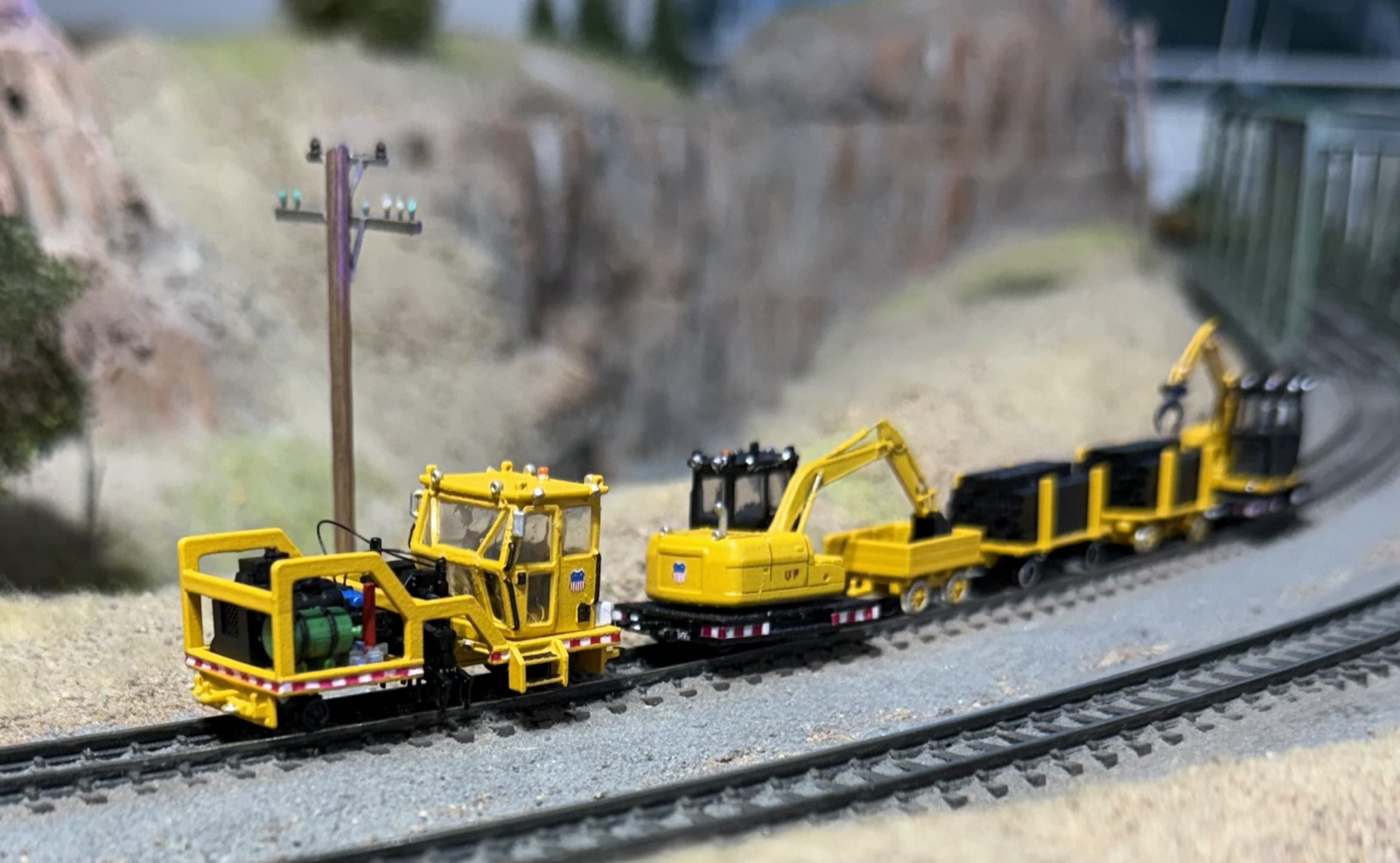 Yellow maintenance-of-way train working the canyon